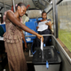 A woman casts her vote in an old bus being used as a polling station in Guinea's presidential election.